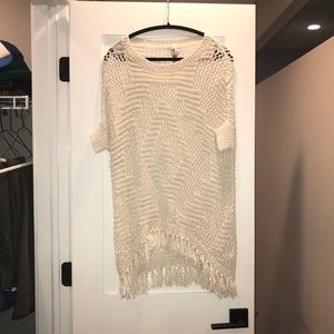 Cream colored poncho with fringe detail